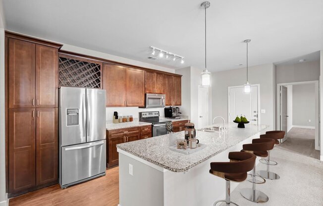 a kitchen with stainless steel appliances and a marble counter top