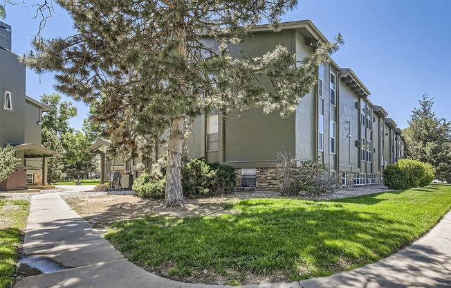 our apartments are located next to a sidewalk and trees