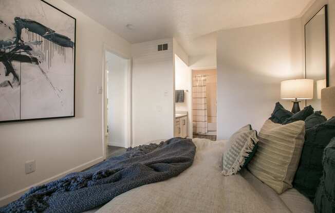 a bedroom with a large bed and a bathroom