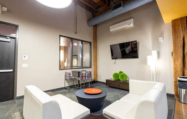 A modern living room with a white sofa and a black coffee table.
