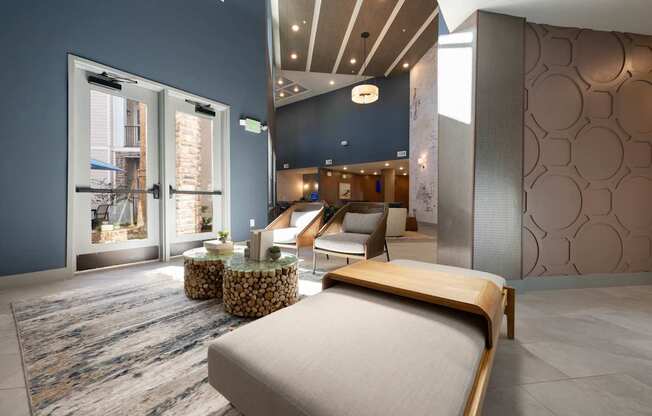 A bedroom with a large bed and a view of a balcony through the window.