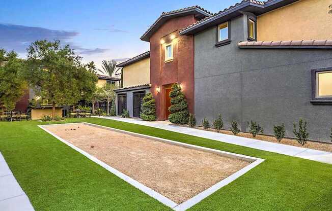 A house with a brown and grey exterior and a green lawn.