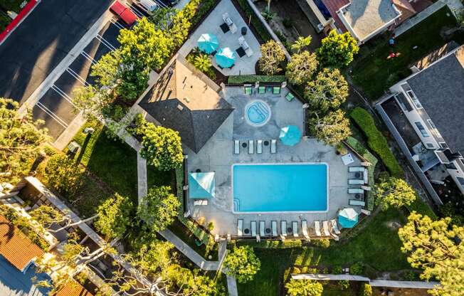 a birds eye view of the pool and backyard of a house