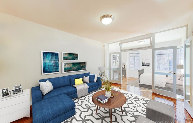 living area with sofa, coffee table, hardwood floors and view of bedroom at baystate apartments in washington dc