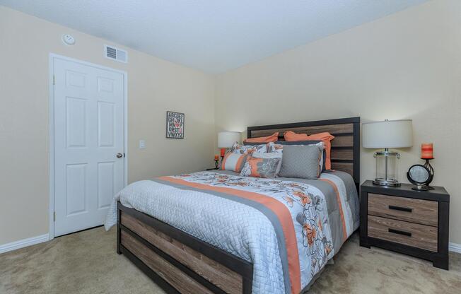 a bedroom with a bed and desk in a room