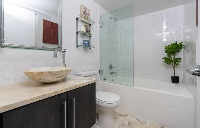 a bathroom with a sink and a toilet and a shower