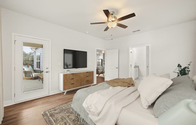 a bedroom with a large bed and a ceiling fan