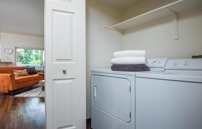Village at Main Street | Laundry Area with Full Size Washer and Dryer and Shelving