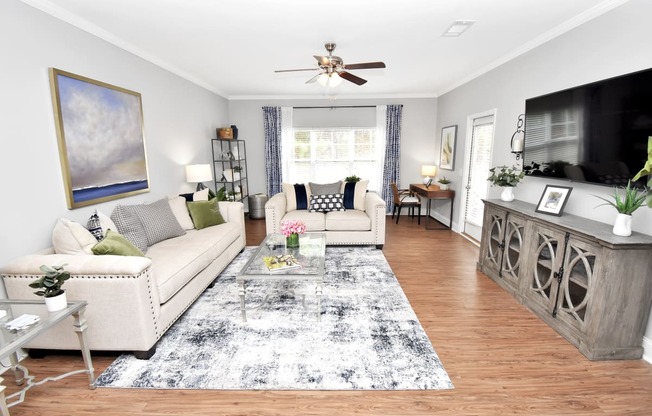 a living room with two couches a coffee table and a tv