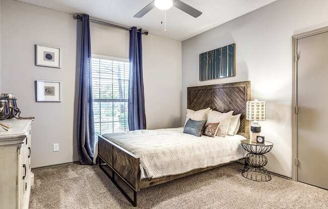 A bedroom with a bed, dresser, and mirror.