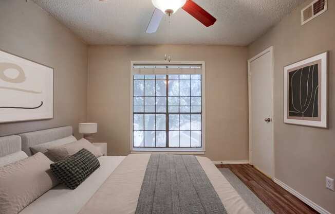 A bedroom with a large bed and a window.