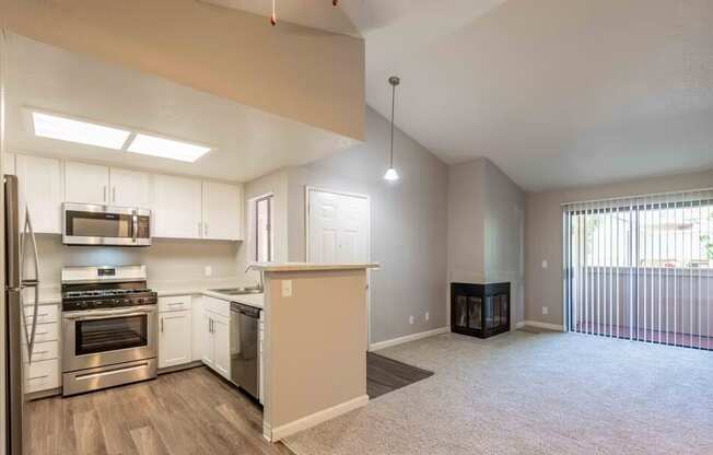 A spacious kitchen with stainless steel appliances and a large island.