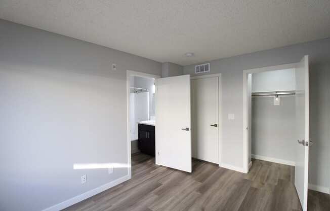 an empty living room with white walls and wood flooring