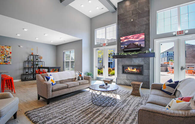 A living room with a fireplace and a television.