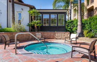 Hot tub with seating and building in the background