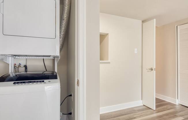 a kitchen with a stove and a refrigerator and a closet