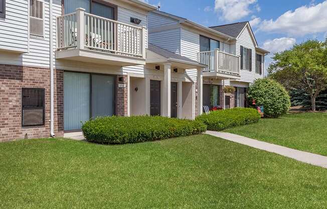 Apartment building with a green lawn in front.