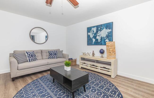 a living room filled with furniture and a rug