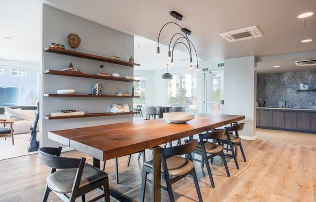 a dining room with a long wooden table and chairs