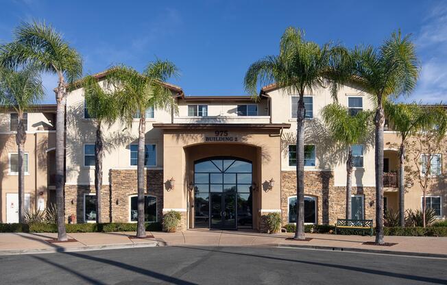 a large brick building with a clock on the side of a road