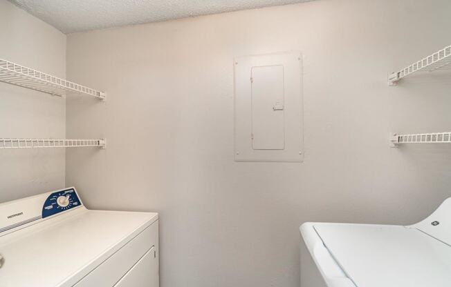 a white laundry room with a washer and dryer