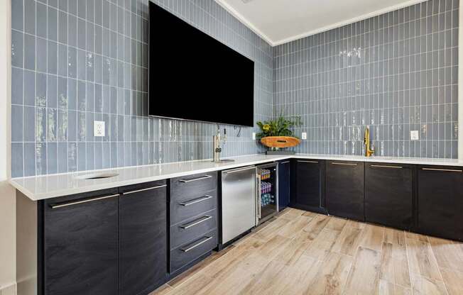 A kitchen with a black screen on the wall.