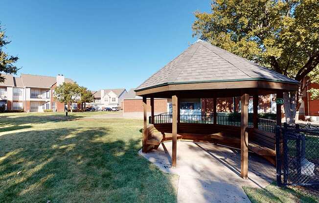 a gazebo sits in the middle of a grassy area