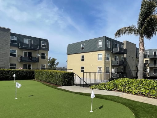 a golf course in front of an apartment building