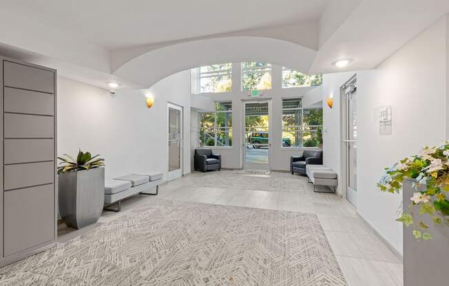 A hallway with a bench and a plant.