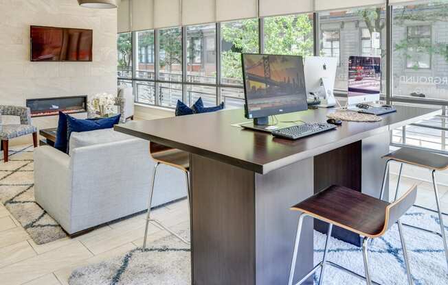 Resident lounge with desk with a computer at The View at Old City, Philadelphia