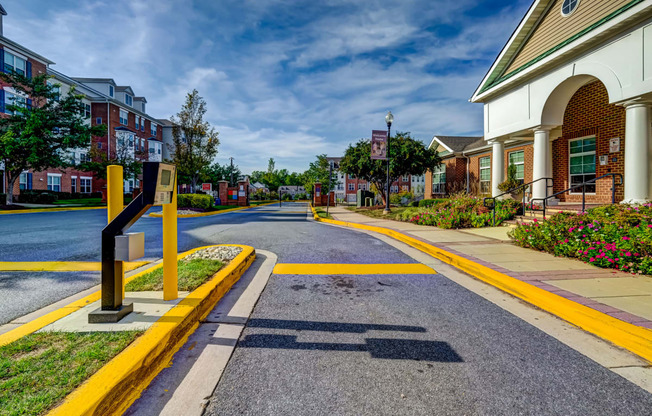 an empty street in a town with buildings and a street sign at MetroPlace at Town Center, Camp Springs