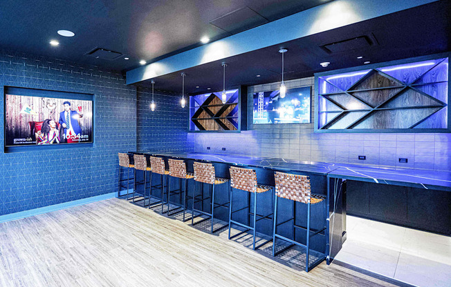 3thirty3 new rochelle ny apartment high rise photo of sports pub area with bar seating and multiple televisions TVs and modern furniture and lighting