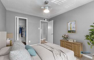 A bedroom with a bed, dresser, and closet.