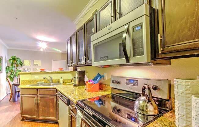 a kitchen with stainless steel appliances and a microwave