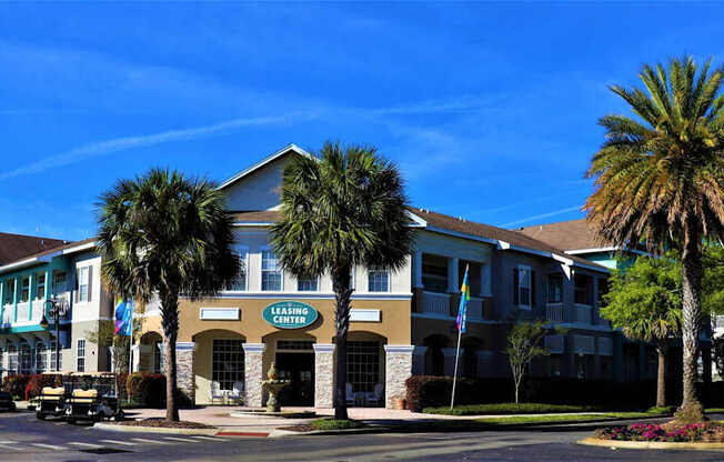 A building with a sign that says "Living Center" is surrounded by palm trees.
