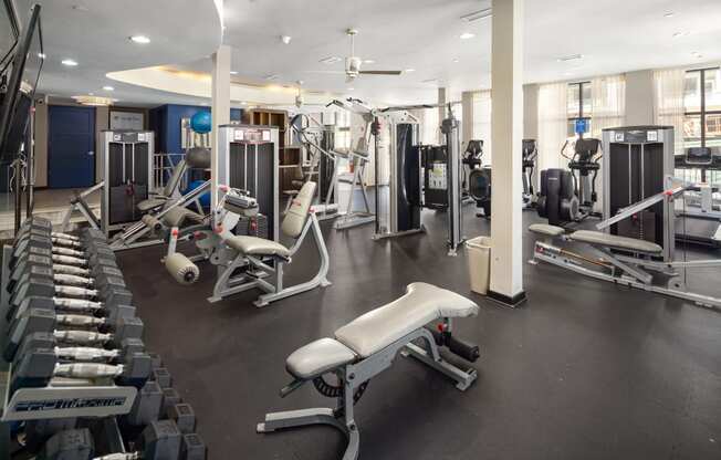 a gym with a lot of exercise equipment and weights