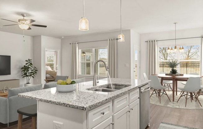 an open kitchen and living room with an island and a sink