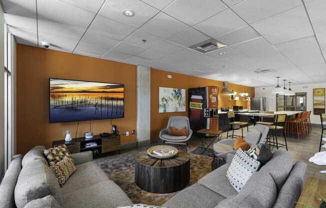 A Community Lounge Room filled with furniture and a large windows at Sedona Apartments, Seattle, Washington