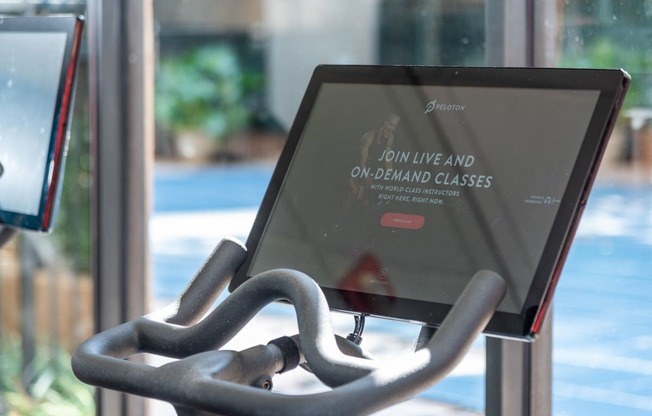 a computer screen sitting on a chair in front of a glass door