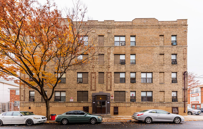 a brick building with a tree in front of it