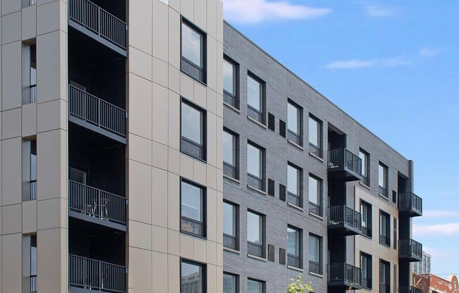 a new apartment building on a city street with a car