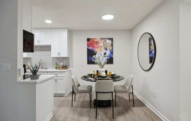 a dining room and kitchen with a table and chairs