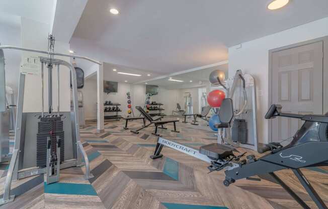 a gym with weights and cardio equipment in a home gym at City View Apartments at Warner Center, Woodland Hills, 91367