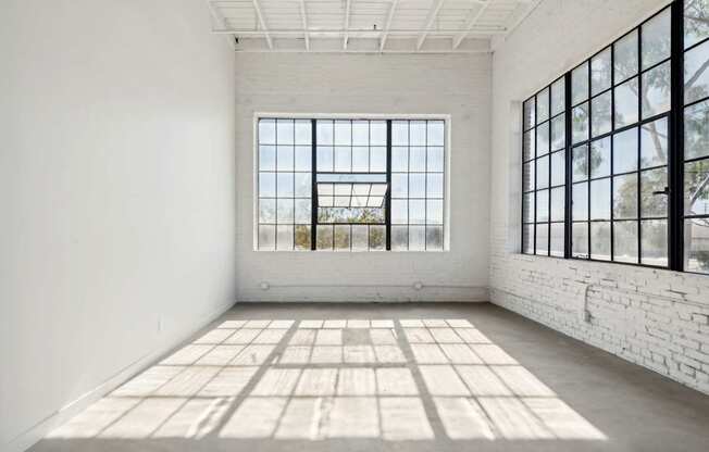 A room with a large window and a tiled floor.