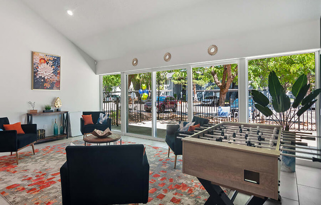 Community Clubhouse with Lounge Furniture and Game Tables at Overlook Apartments located in Salt Lake City, UT.