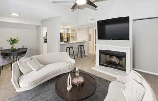 a living room with a white couch and a fireplace