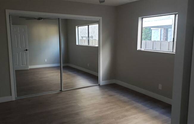 Sliding Door Closet with Mirror in Bedroom at Wilson Apartments in Glendale, CA