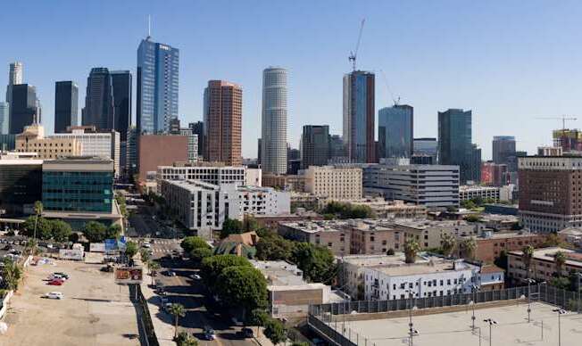 A cityscape with tall buildings and a clear sky.