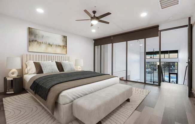 a white bedroom with a large bed and a ceiling fan