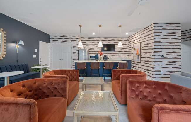 a living room with couches and chairs and a bar